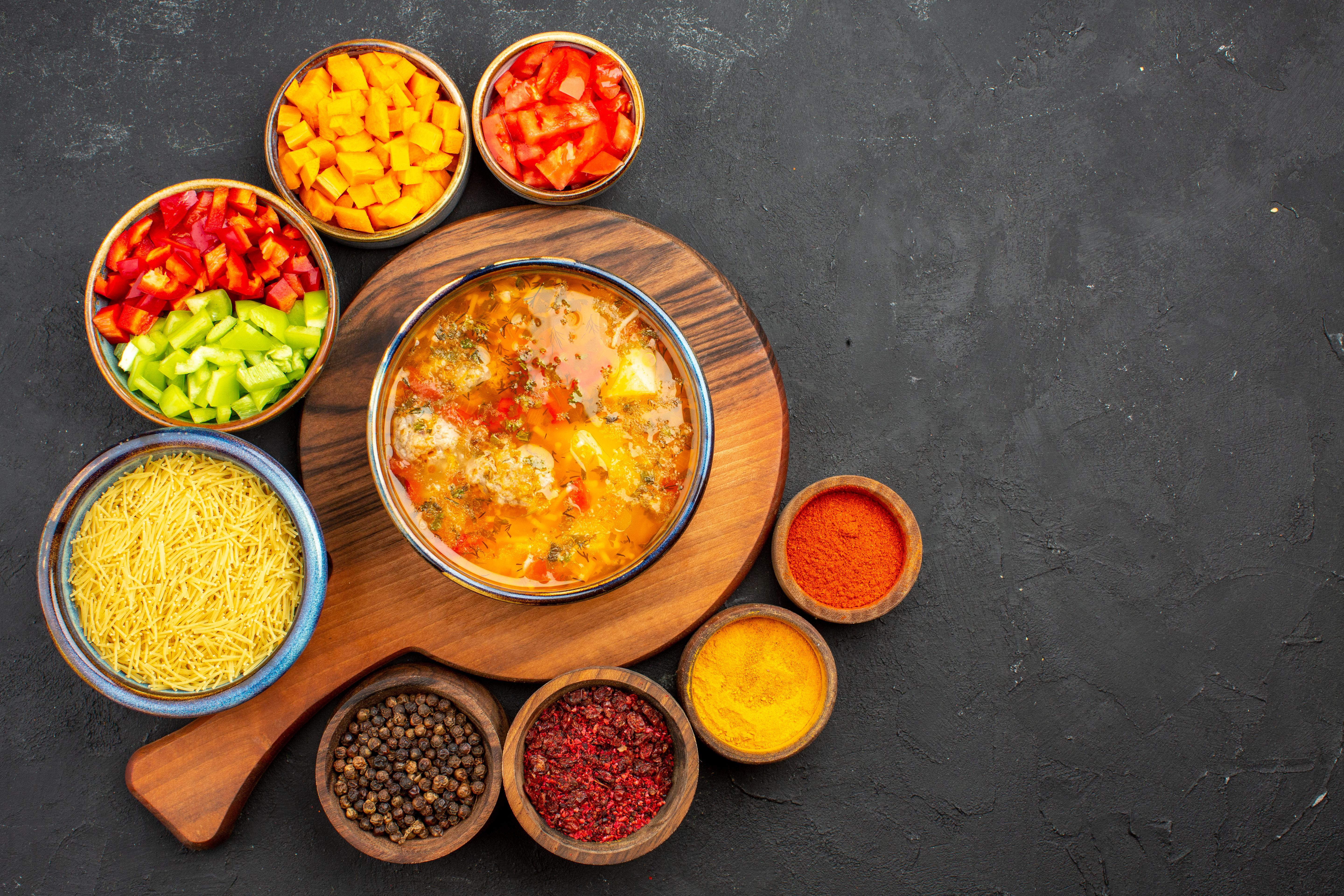 top-view-tasty-soup-with-different-seasonings-sliced-pepper-grey-background-soup-meal-food-meat-seasoning-spicy