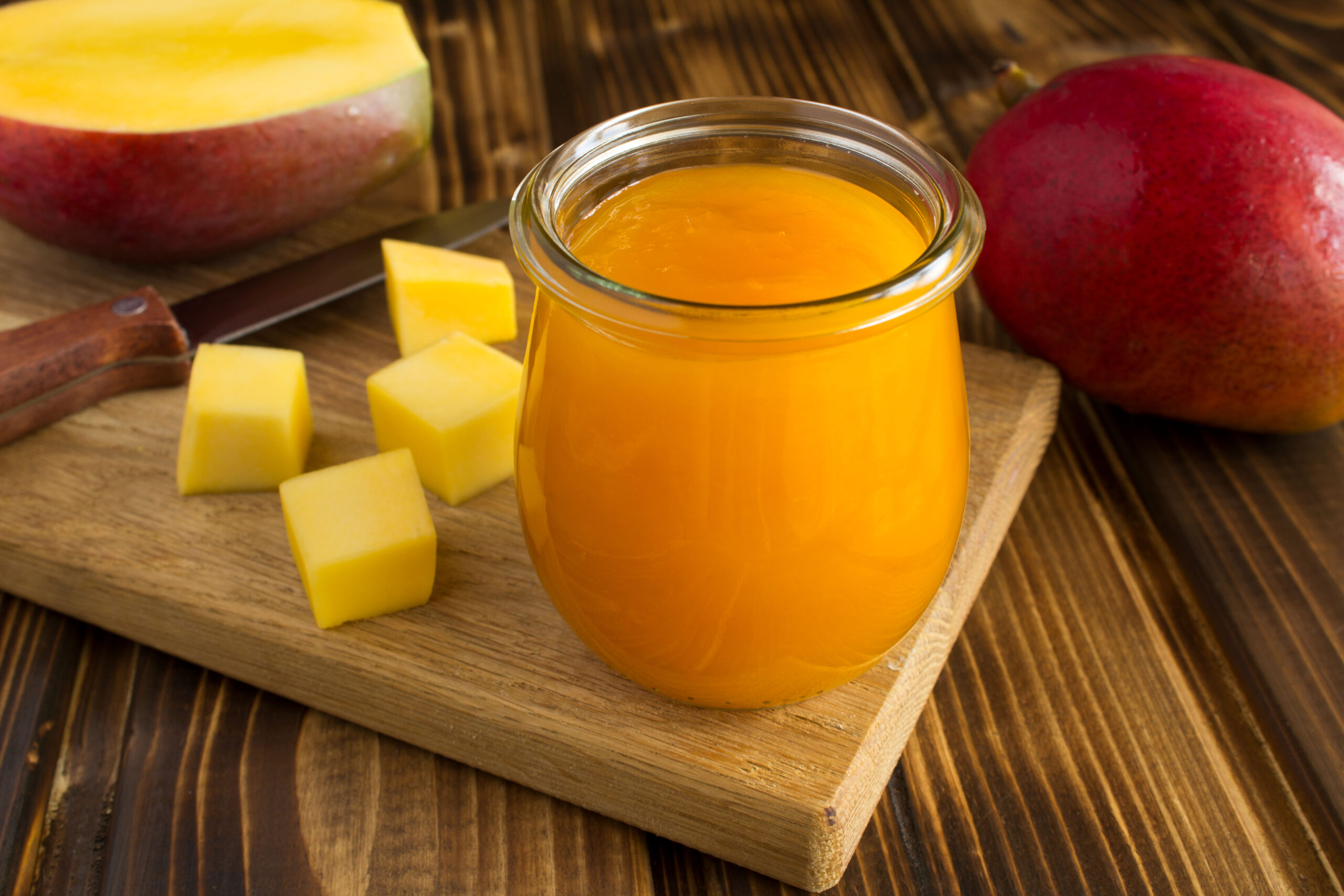 Puree with mango and ingredient on the wooden cutting board