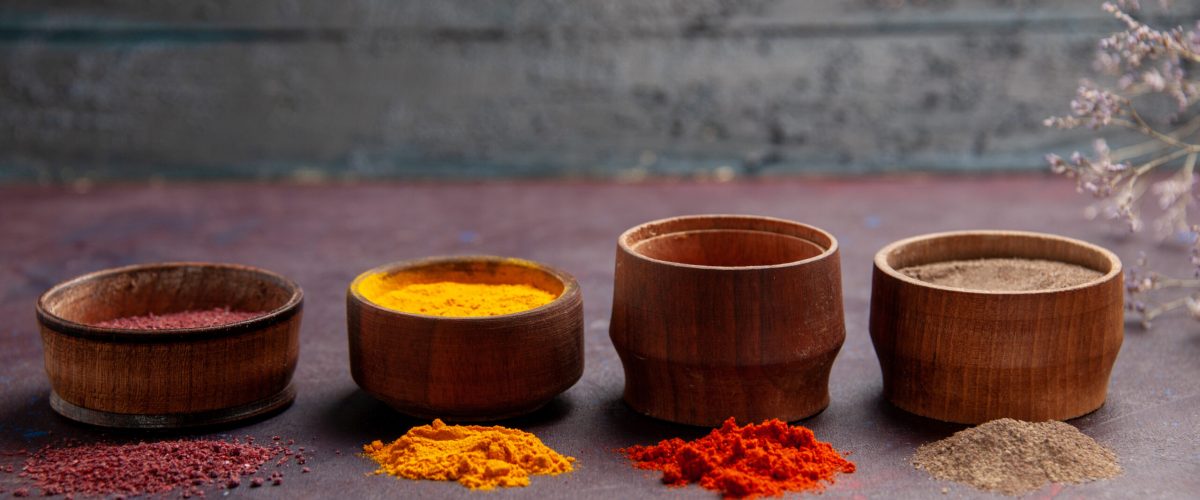 front-view-different-seasonings-inside-pots-dark-space